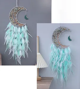 Detail of moon-shaped dream catcher with wire-wrapped tree of life and soft feathers