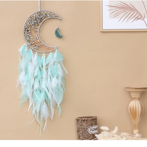 Detail of mint green moon dream catcher wall decor with tree of life crystal wire wrap