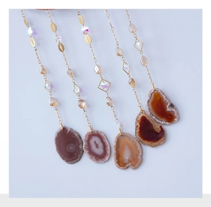 Detail showing five assorted agate slice pendants with handmade tree of life wire wrapping