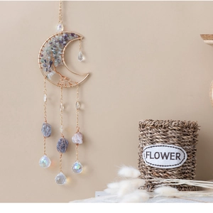 Detail of life tree moon suncatcher with purple fluorite crystals and hanging prisms