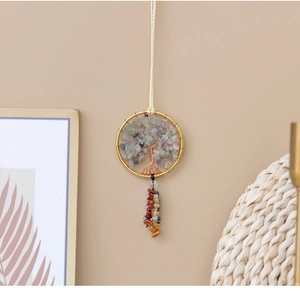 Detail of handmade Tree of Life wall hanging with colorful natural stones and gold wire