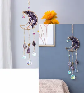 Detail of moon-shaped suncatcher with amethyst stones and a hanging crystal ball