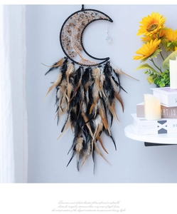Artistic moon-shaped dream catcher with Tree of Life wire weave and hanging feathers
