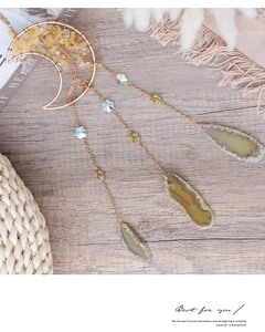 Detail of moon-shaped dream catcher with citrine tree of life and agate slice charm