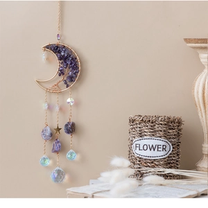 Macro shot of Bohemian moon tree of life suncatcher with purple amethyst and crystal