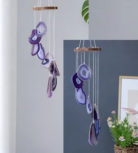 Detail of purple agate slices with natural texture on a wooden wind chime hanger