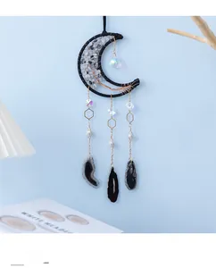 Detail of moon dreamcatcher with tree of life design and hanging agate slices