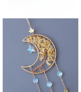Detail of moon-shaped Tree of Life pendant with yellow crystals and gold wire wrapping