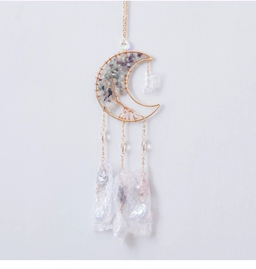 Detailed shot of handmade moon-shaped tree of life suncatcher with purple fluorite stones