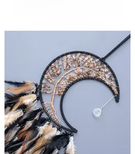 Detailed View of black crescent moon dream catcher with tree of life and brown feathers
