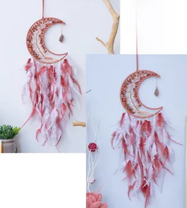 Detail of moon dreamcatcher showing natural crystal stone tree of life and red white feathers