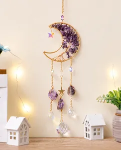 Macro view of golden crescent moon tree of life hanging with purple amethyst stones