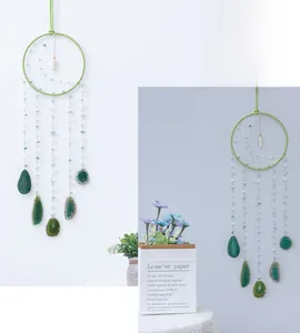 Detail of hand-woven dreamcatcher featuring green agate slices and beaded strands