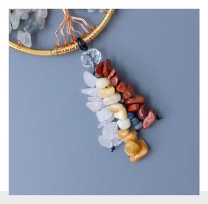 Detailed view of handmade copper wire-wrapped tree of life with colorful natural gemstones