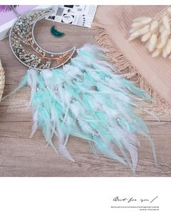 Detailed view of handmade moon dreamcatcher with life tree stone inlay and soft feathers