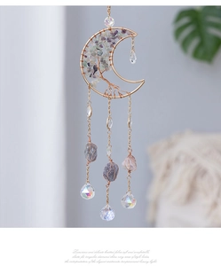 Detail of moon suncatcher with wire wrapped life tree and purple crystal stone