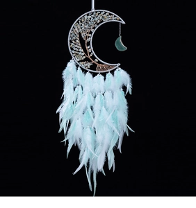 Detailed view of handmade moon dreamcatcher with crystal tree of life and soft feathers