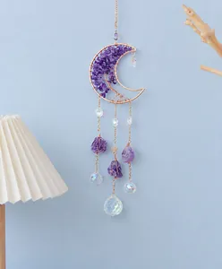 Close-up of golden moon sun catcher with amethyst tree of life and crystal prisms