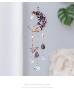 Detail of amethyst moon sun catcher with golden tree of life and crystal ball pendant