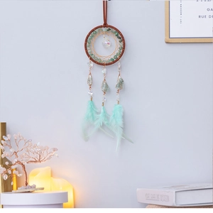 Detail of dream catcher with green turquoise crystals and mint green feathers decor