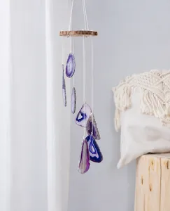 Detail of purple agate slices and natural wood top of this handcrafted wind chime