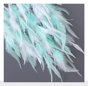 Detail of white and mint green feathers with small white pearls for dreamcatcher decor
