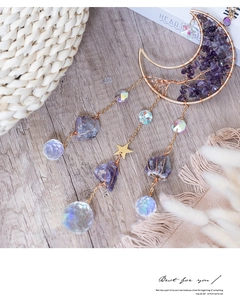 Detailed view of handmade amethyst tree of life inside a golden moon suncatcher decoration