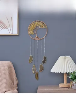 Detail of life tree wall hanging with yellow crystal chips and agate slices on gray wall