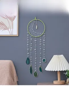 Nordic woven half moon dreamcatcher with green agate slices and white crystal on gray wall