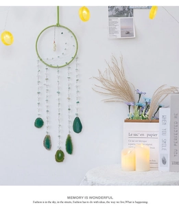 Detail of bohemian half moon dreamcatcher with green agate stones and handwoven beads