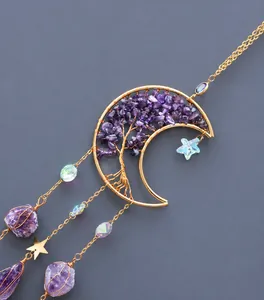 Detail of amethyst crystal tree of life inside a crescent moon wire frame hanging decoration