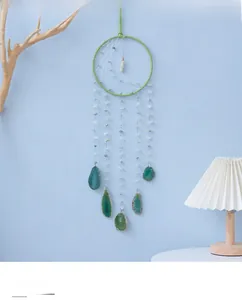 Detail of green agate slices hanging from a Nordic handmade dreamcatcher wall hanging