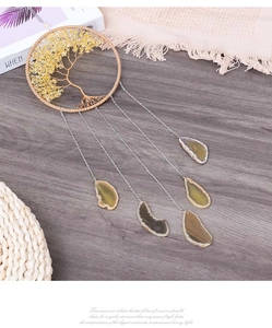 Detail of tree of life suncatcher with yellow crystal stones and natural agate slices