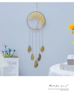 Detail view of handmade tree of life wind chime with yellow quartz and agate slices