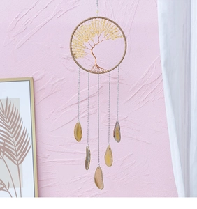 Detail of tree of life wall hanging with yellow crystals and natural agate slices
