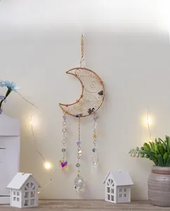 Detail of moon-shaped amethyst suncatcher with wire-wrapped crystals and sun-reflecting prisms