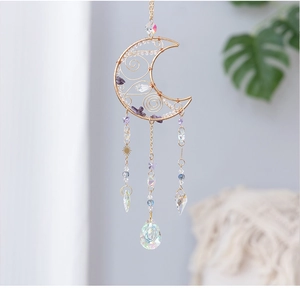 Close-up of moon-shaped amethyst suncatcher with wire-wrapped purple stones and crystals