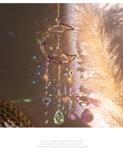 Moon amethyst suncatcher pendant casting colorful rainbow reflections on the wall