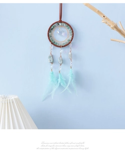 Detail of dream catcher car hanging with turquoise beads, crystal, and feathers