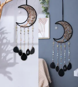 Detail of moon-shaped tree of life wall hanging with gravel stones and black agate slices