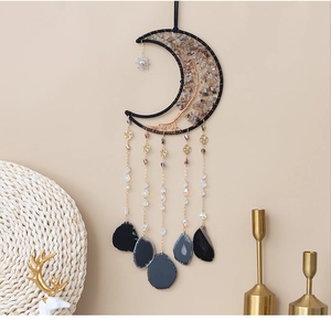 Close-up of moon dream catcher with citrine tree of life and agate slices
