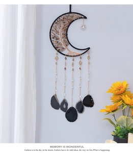 Detailed close-up of Bohemian moon dream catcher with tree of life and black agate slices