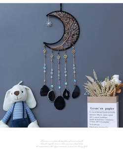 Macro detail of moon dream catcher with tree of life crystal and agate tassels