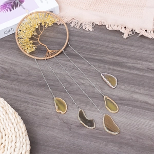 Tree of Life wall hanging with yellow crystals and natural agate slices on wood background