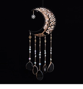 Detail of moon-shaped dreamcatcher featuring Tree of Life wire weave and black agate slices