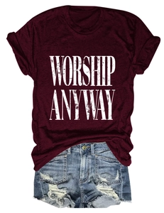 Flat lay of a burgundy crew neck T-shirt with 'WORSHIP ANYWAY' text and denim shorts