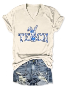 Flat lay detail of V-neck T-shirt with TEACH floral bunny print and distressed denim shorts