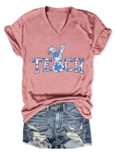 Detail of V-neck pink T-shirt with blue floral TEACH text and rabbit graphic design