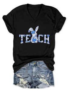 Detail of V-neck black T-shirt with blue floral TECH rabbit print and ripped denim shorts