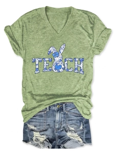 Detail view of V-neck T-shirt with TEACH rabbit print and ripped denim shorts